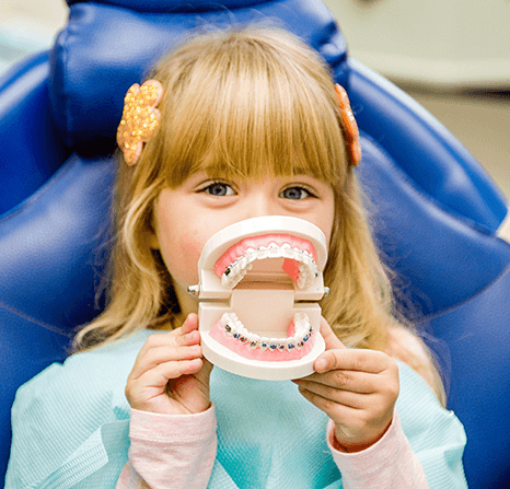 Girl showing a denture.